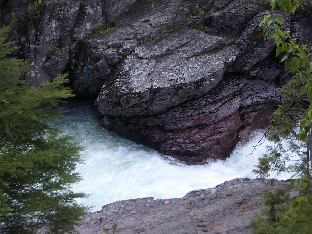 Rushing water between two large sedimentary rocks 