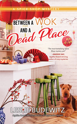 Between a Wok and a Dead Place -- book cover, showing shop interior decorated for the Lunar New Year, and an Airedale terrier